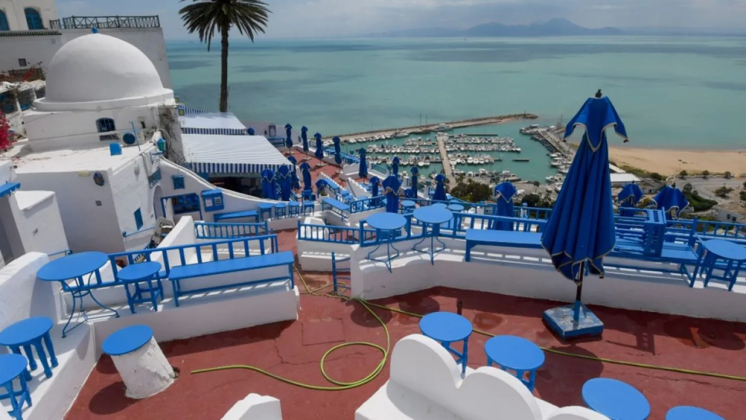 A cafe stands empty in the Tunisian village of Sidi Bou Said, where streets are usually filled with tourists at this time of year | AFP