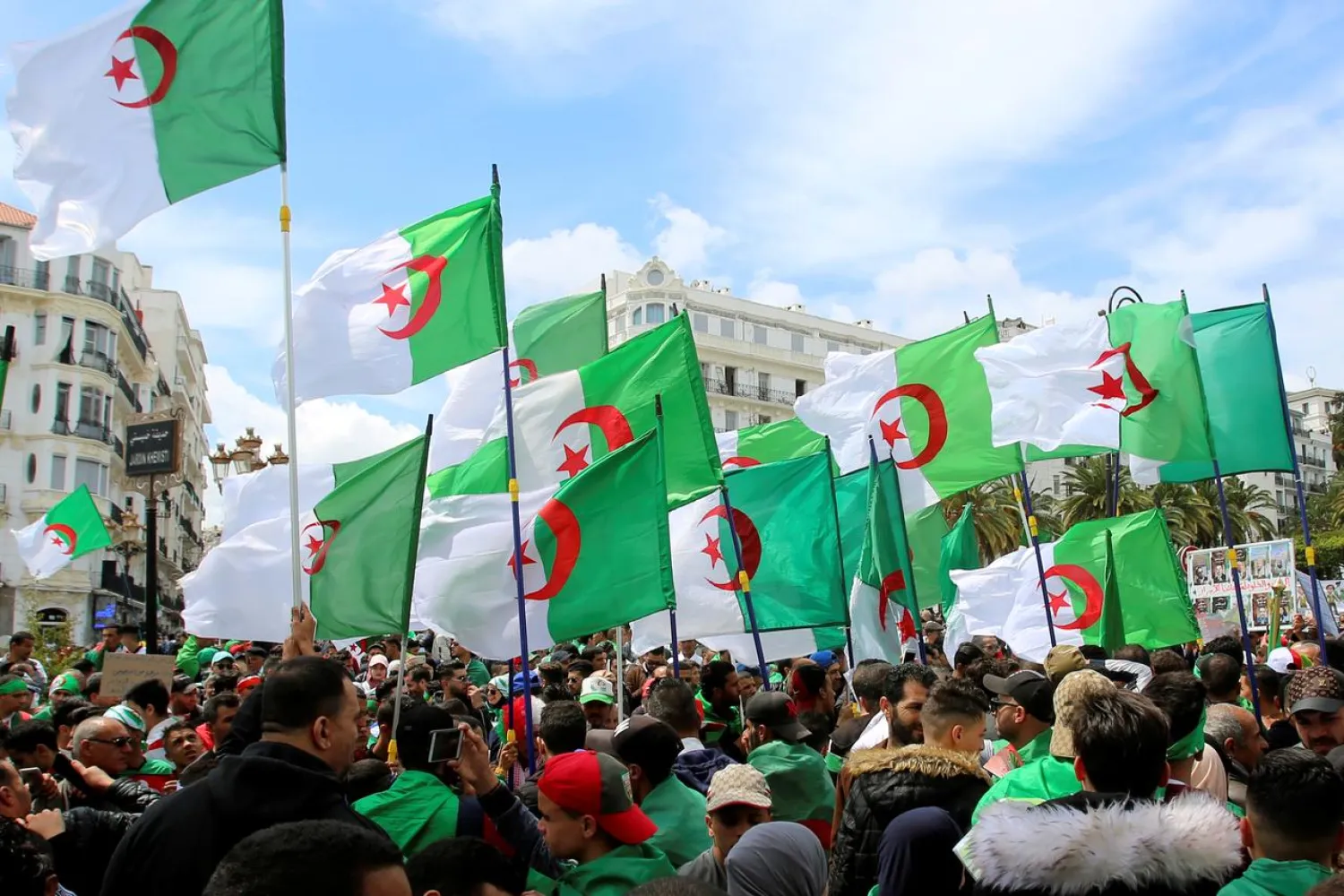 People carry national flags during a protest seeking the departure of the ruling elite in Algiers, Algeria April 12, 2019. REUTERS/Ramzi Boudina
