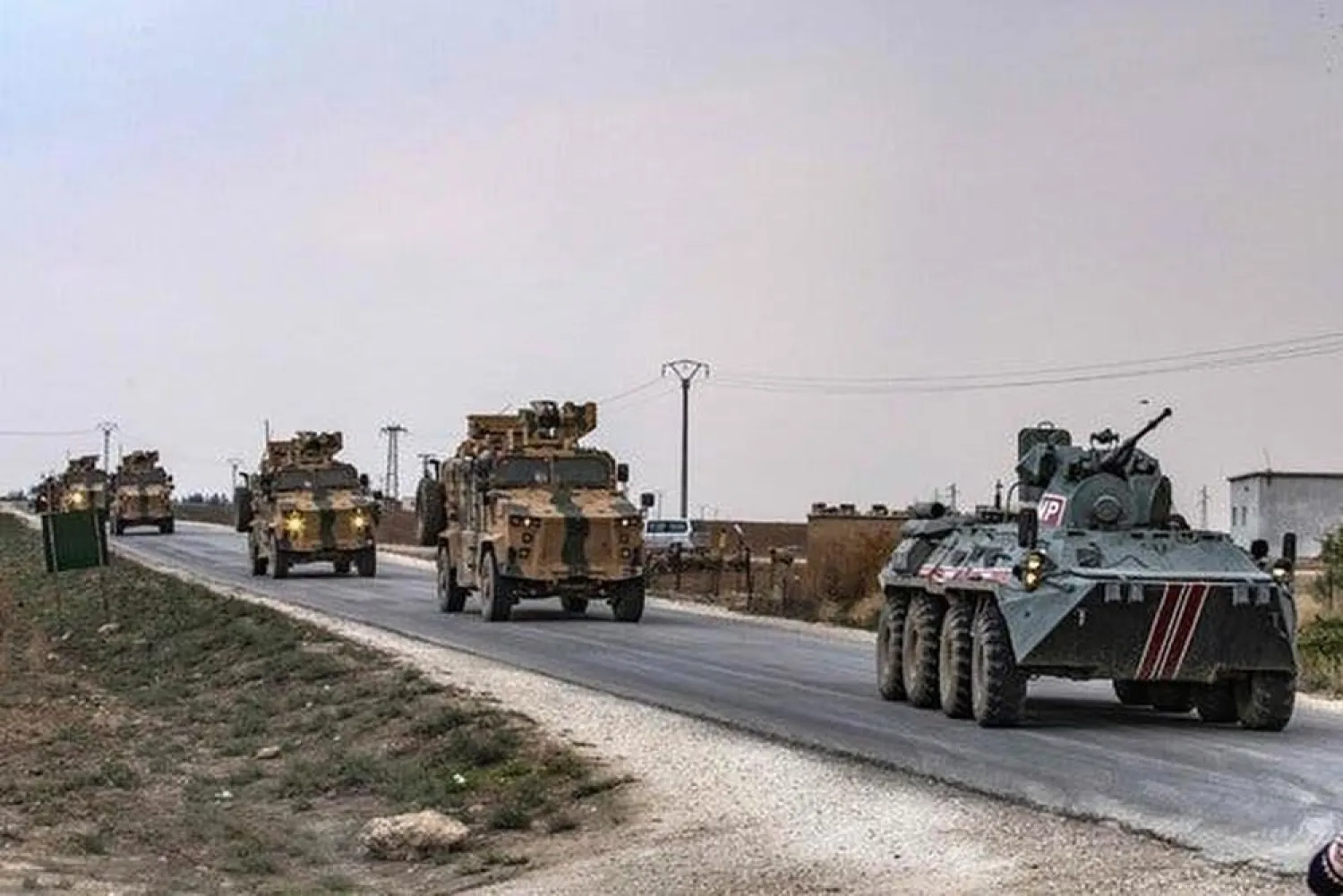 Russian (front) and Turkish military vehicles patrol in the countryside of Darbasiyah town in Syria's northeastern Hasakeh province on the Syrian-Turkish border on November 1, 2019. (AFP / Delil Souleiman)