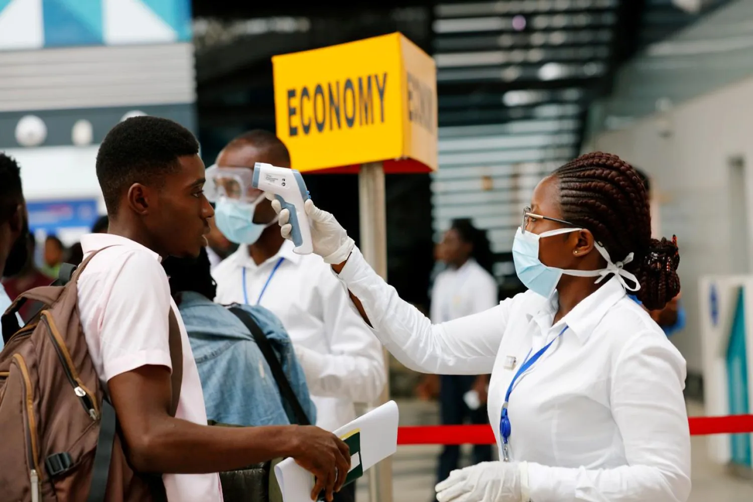 A health worker checks the temperature of a traveller as part of the coronavirus screening procedure at the Kotoka International Airport in Accra, Ghana January 30, 2020. (Reuters)