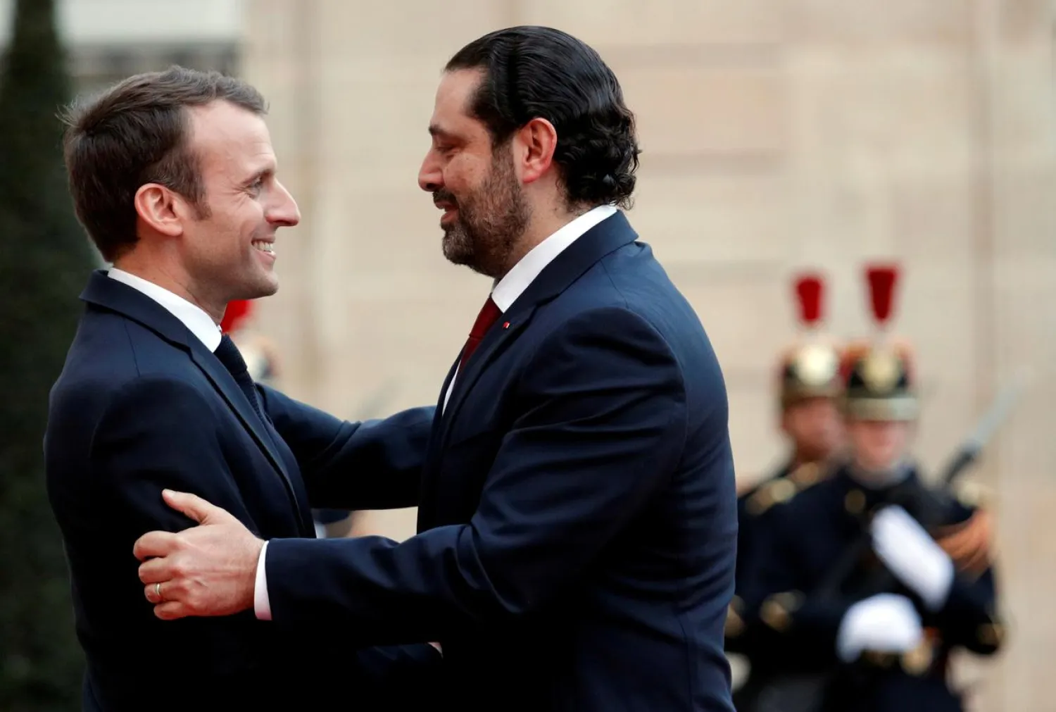 French President Emmanuel Macron welcomes then-Lebanese Prime Minister Saad Hariri as he arrives at the Elysee Palace in Paris, France, April 10, 2018. REUTERS/Philippe Wojazer