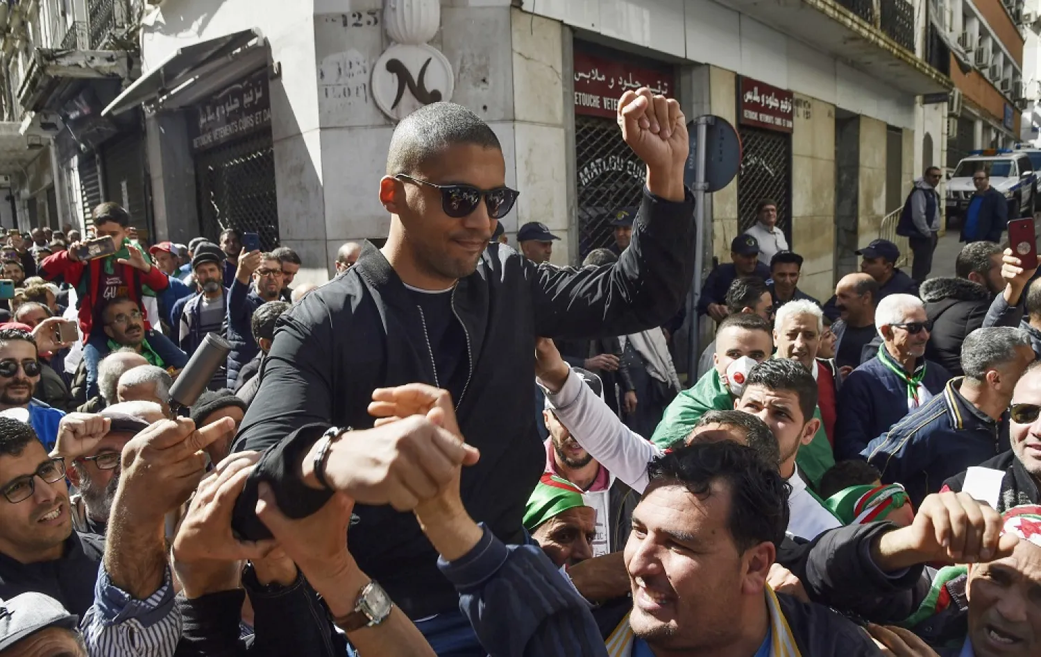 This photo taken March 6, 2020, shows Algerian protesters carrying journalist Khaled Drareni on their shoulders after he was briefly detained by security forces in Algiers. (AFP)
