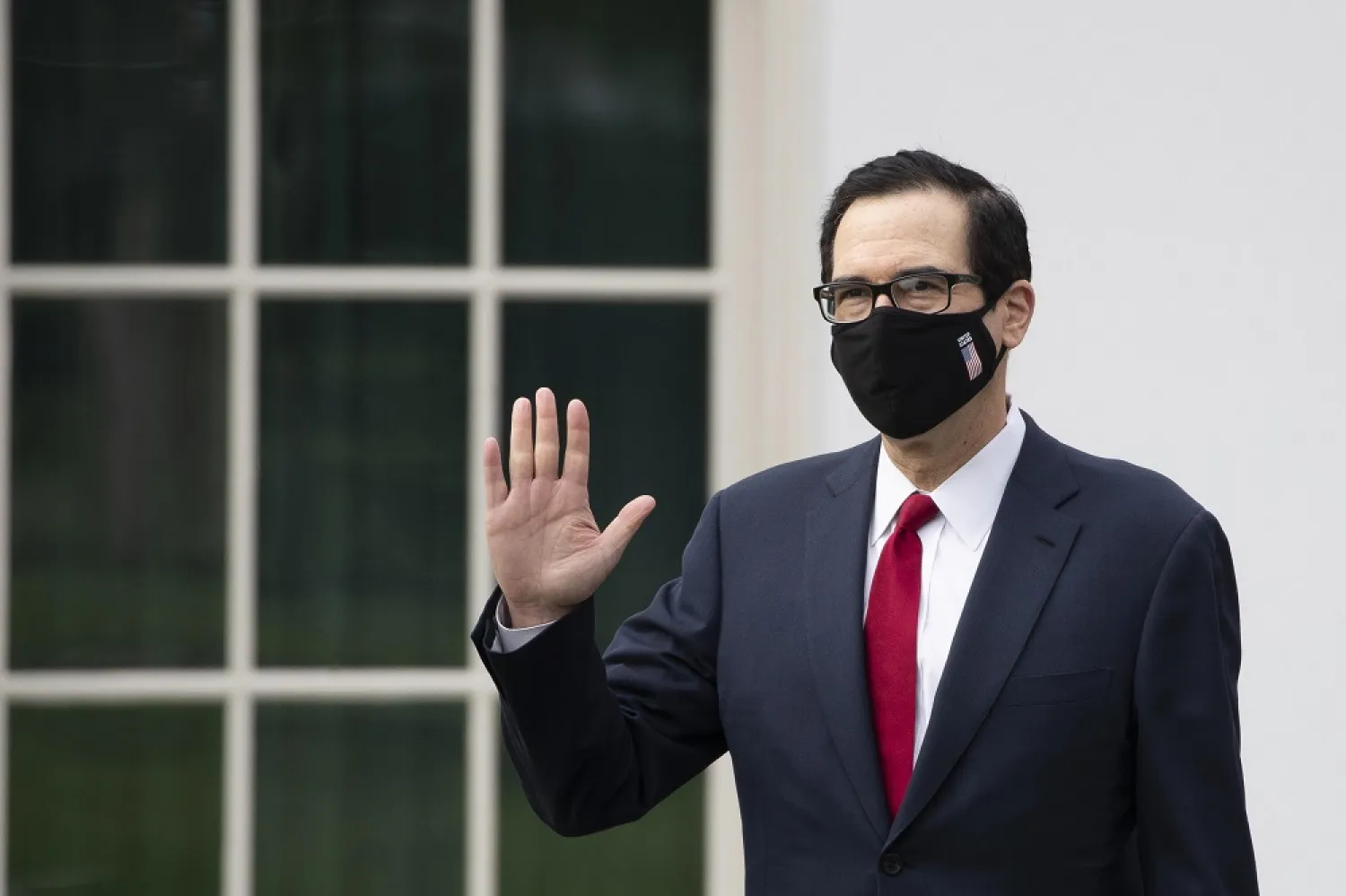 US Treasury Secretary Steven Mnuchin wears a mask as he walks on the grounds of the White House, May 14, 2020, in Washington. (AP)