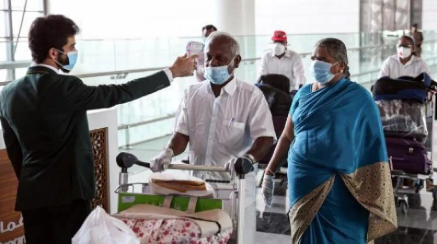Indian residents getting their body temperature measured in muscat. AFP