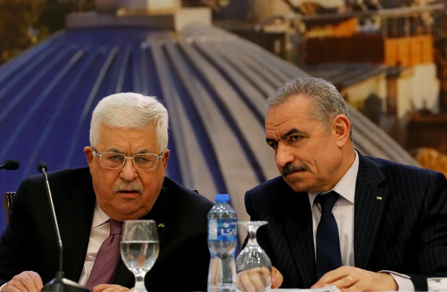 Palestinian President Mahmoud Abbas looks on as Palestinian Prime Minister Mohammad Shtayyeh sits next to him as Abbas delivers a speech following the announcement by US President Donald Trump of the Mideast peace plan, in Ramallah in the Israeli-occupied West Bank January 28, 2020. REUTERS/Raneen Sawafta/File Photo
