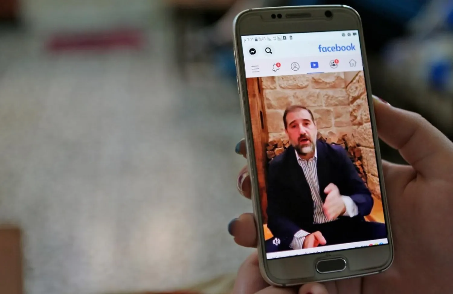 Makhlouf appears in an online video message appealing to Assad. (AFP)