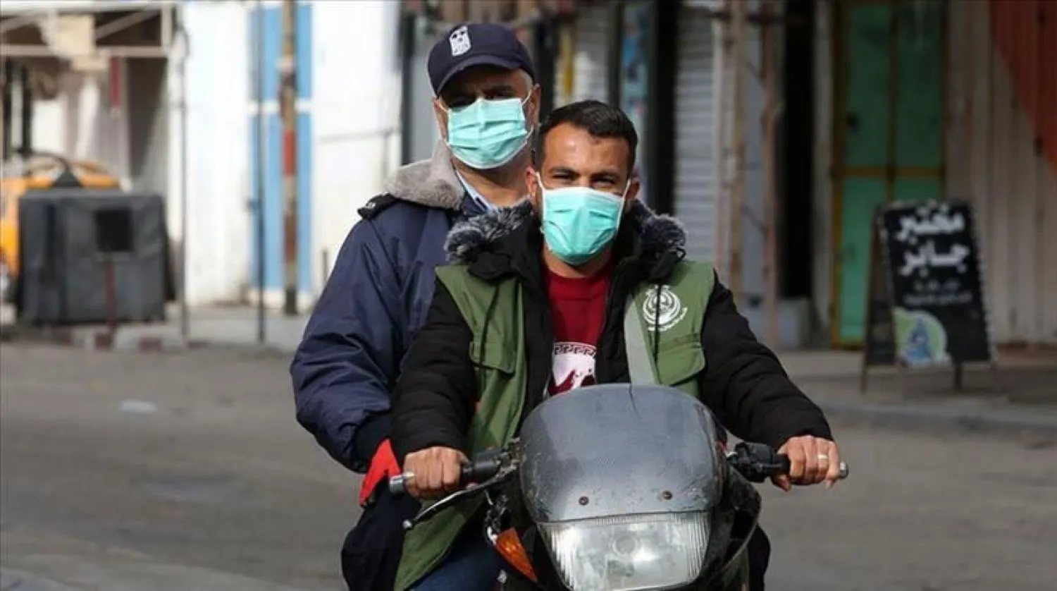 Palestinians wearing face masks. AAWSAT AR