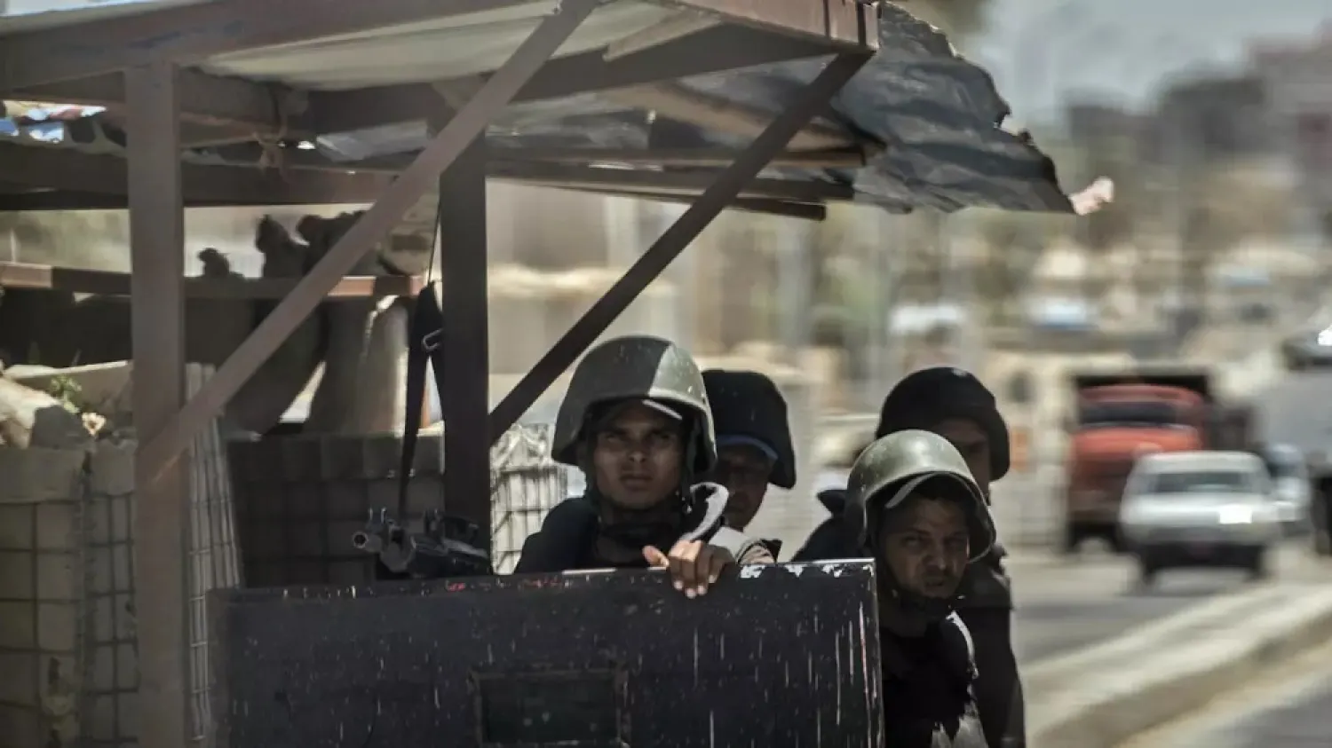 Egyptian policemen stand guard at a checkpoint on a road leading to the North Sinai provincial capital of El-Arish in July 2018. (AFP)