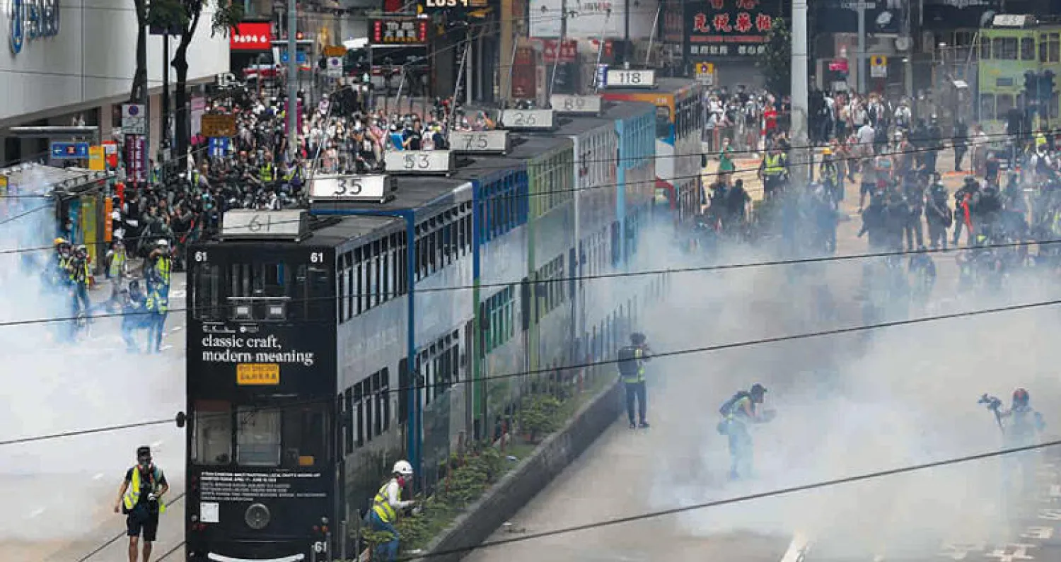 الشرطة تطلق قنابل الغاز على المتظاهرين في كوزواي باي وسط هونغ كونغ أمس (إ.ب.أ)