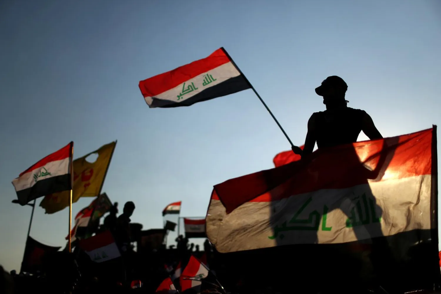 Iraqi demonstrators wave flags during the ongoing anti-government protests in Baghdad, Iraq November 1, 2019. (Reuters)