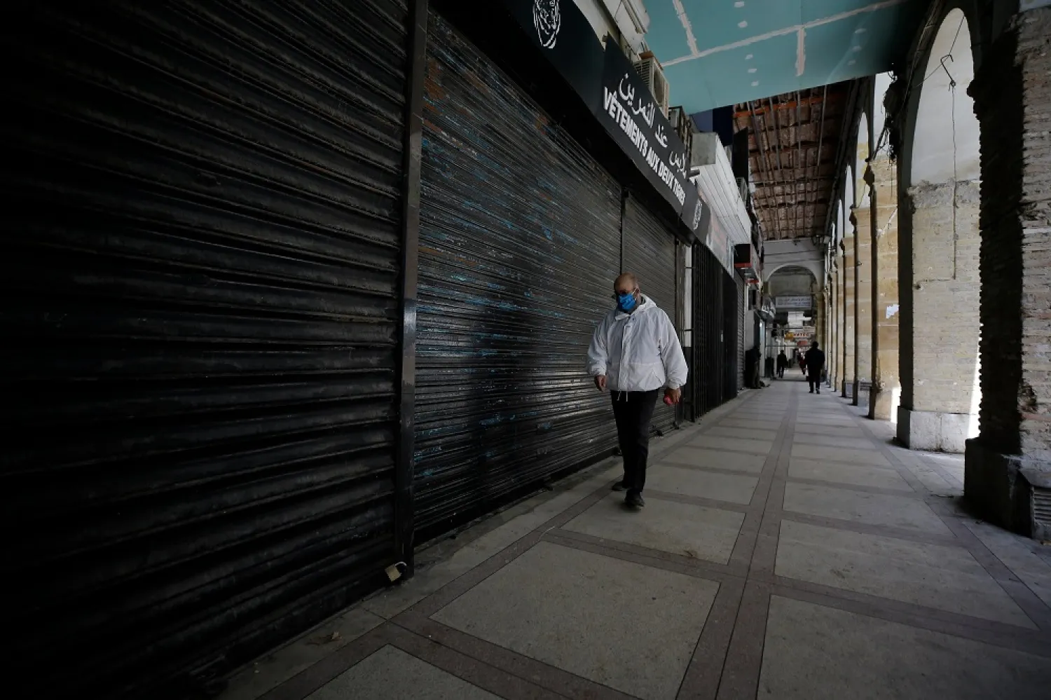 A man walks by closed shops in Algiers, Wednesday, April 29, 2020. (AP)