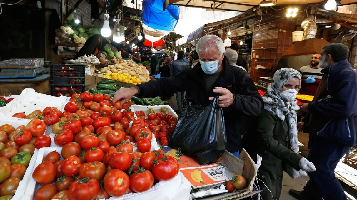 A man wears a face mask amid concerns over the coronavirus as he buys vegetables in Amman, Jordan, April 12, 2020. (Reuters)