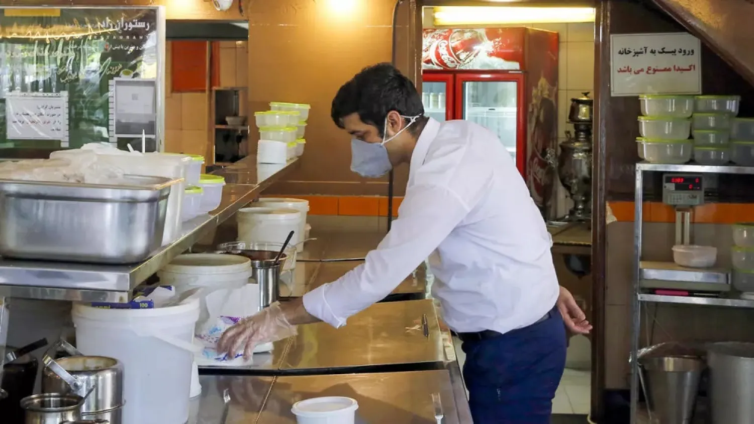 A restaurant employee waits for customers in the Iranian capital Tehran. (AFP)