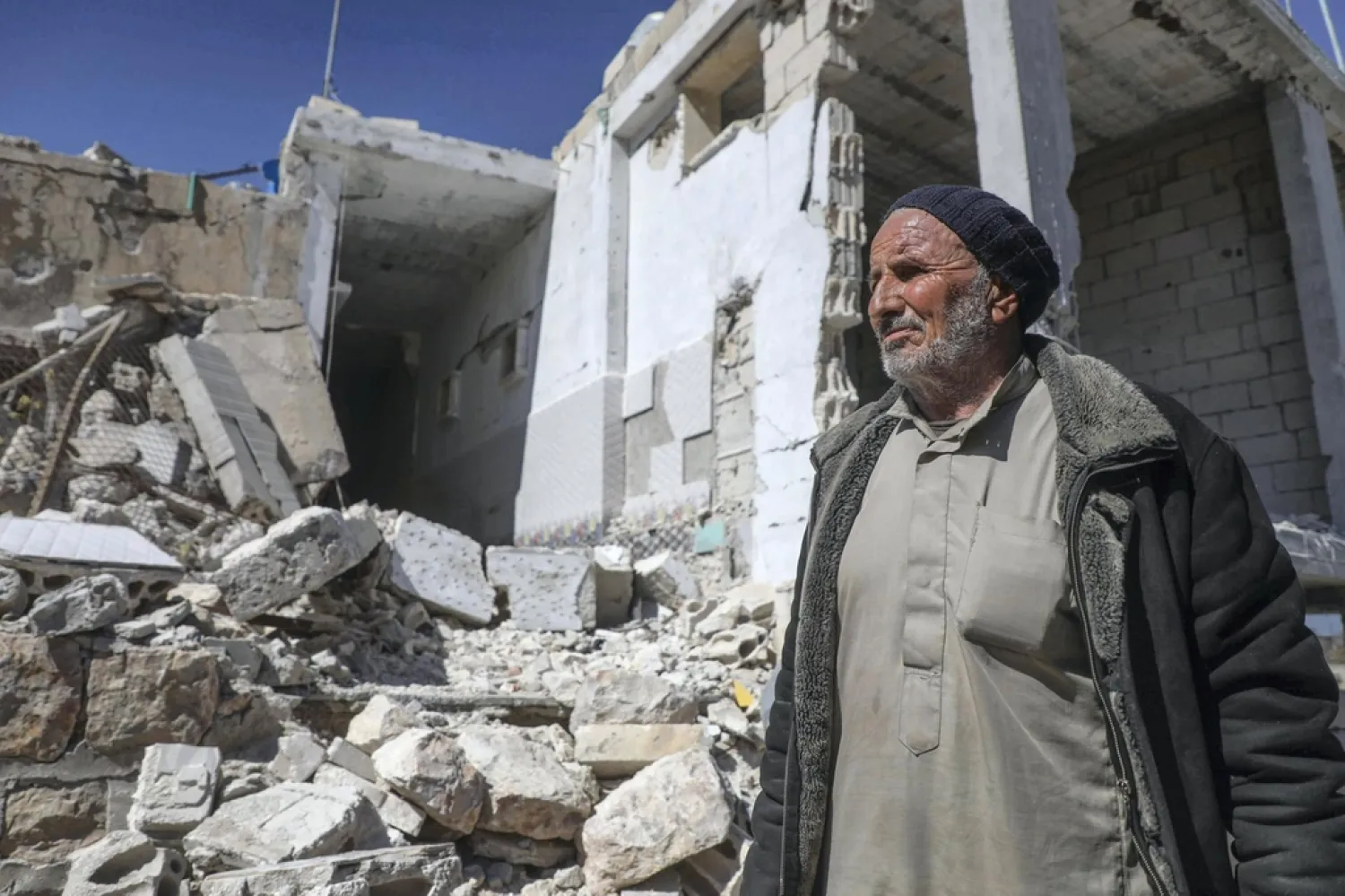  A resident of Jabal Al Zawiya region of Idlib at his destroyed house on March 8, 2020 following a Russian-Turkish ceasefire deal. AFP 
