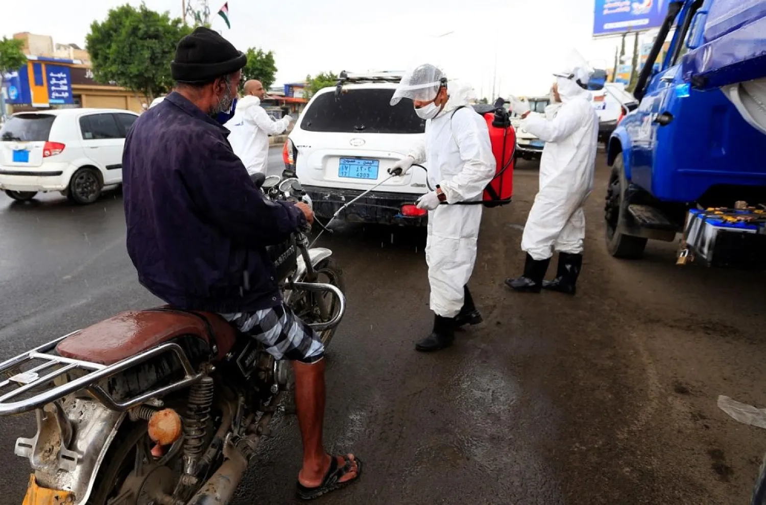 A health worker sprays disinfectant on a motorcycle in Sanaa on May 21, 2020. (AFP)