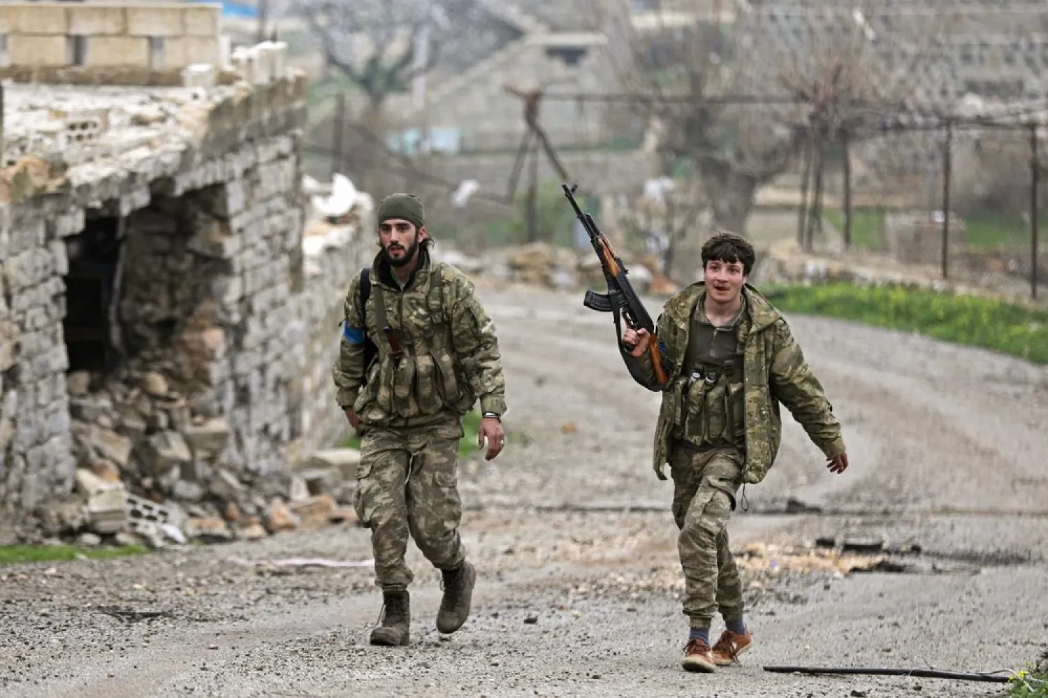 A Turkish-backed Free Syrian Army fighter walks as he holds his weapon near the city of Afrin, Syria. (Reuters)