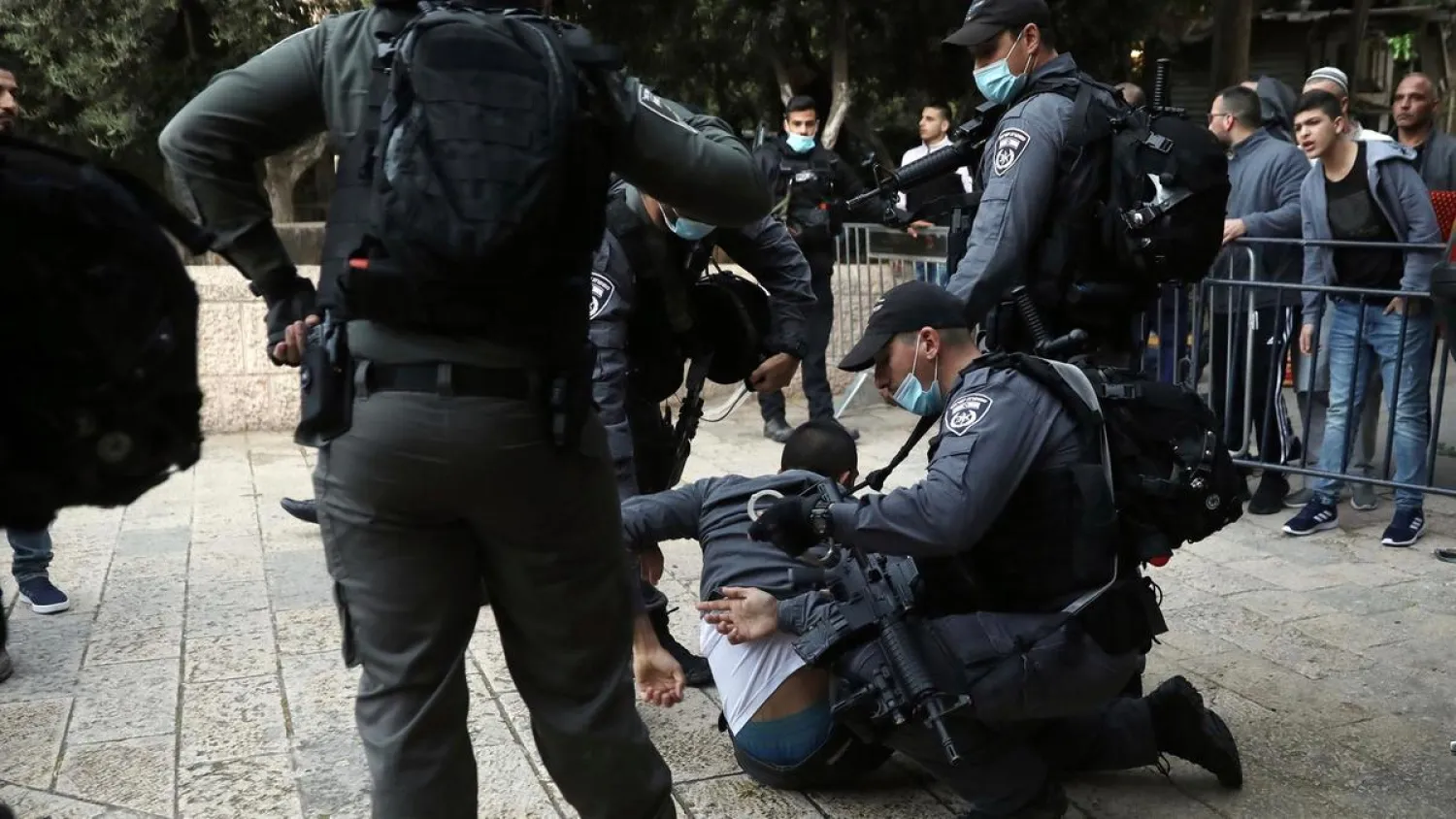  Israeli police officers detain a Palestinian man who tried to break through a security barrier to enter Al Aqsa Mosque compound in Jerusalem, on Sunday, May 24, 2020. AP

