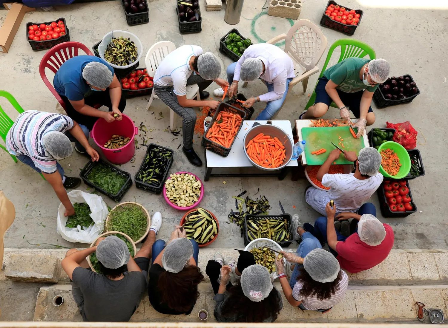 FILE PHOTO: Volunteers prepare food for distribution to people in need, amid concerns over the spread of the coronavirus disease (COVID-19), in the port city of Sidon, southern Lebanon May 27, 2020. REUTERS/Ali Hashisho/File Photo