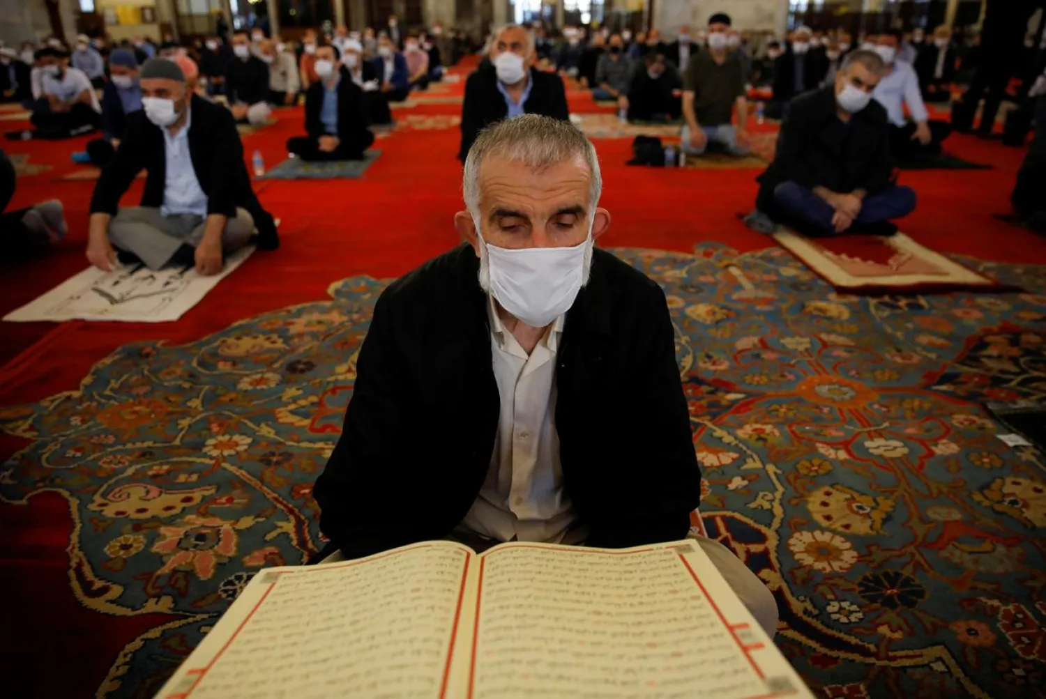 A worshipper wearing a face mask attends the Friday prayers at the Fatih Mosque, which is partly open again for prayers, amid the coronavirus outbreak, in Istanbul, Turkey May 29, 2020. (Reuters)