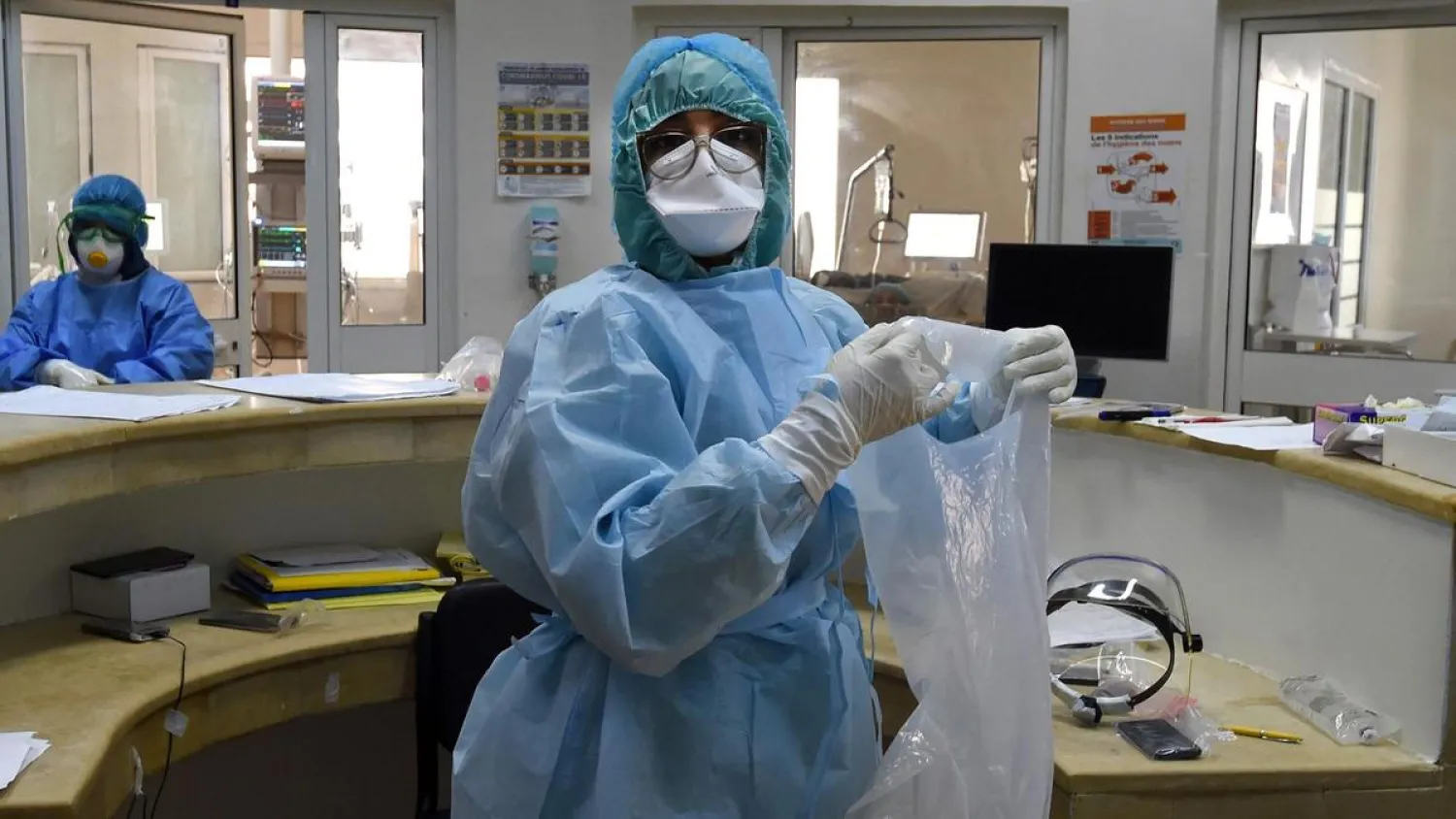 Members of the medical staff of the Ariana Mami hospital, where patients of COVID-19 are being treated, work at the special care unit, in the city of Ariana near Tunis. (AFP)