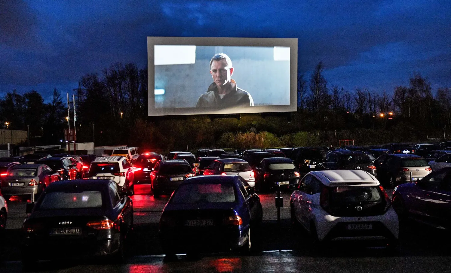 People sit in cars, watching a movie trailer at a drive-in
cinema in Essen, Germany, on March 30, 2020. /AP
