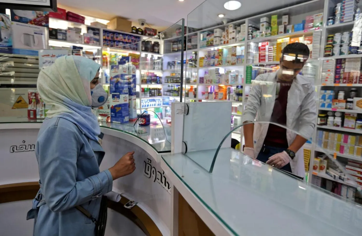A customer wears a protective masks at a pharmacy in the Iranian capital Tehran on February 24, 2020. (AFP)