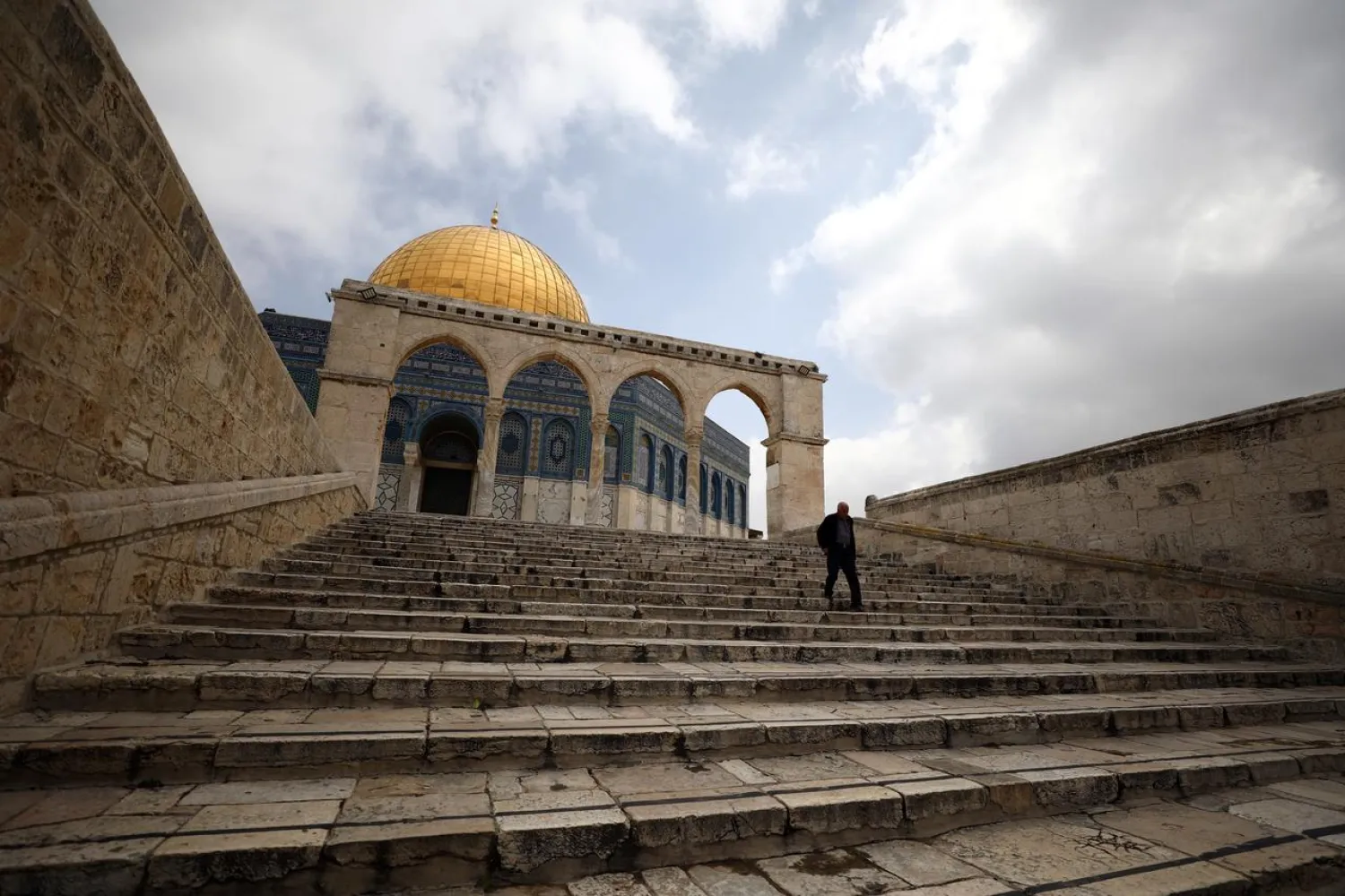 A man walks in front of the Dome of the Rock in the compound known to Muslims as Noble Sanctuary in Jerusalem's Old City on March 15, 2020. (Reuters)