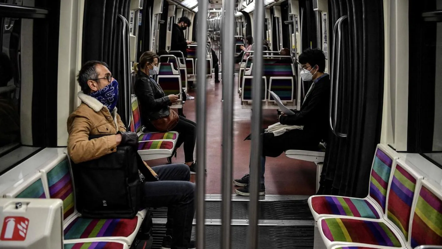 Commuters observe social distancing rules on a metro train. (AFP)