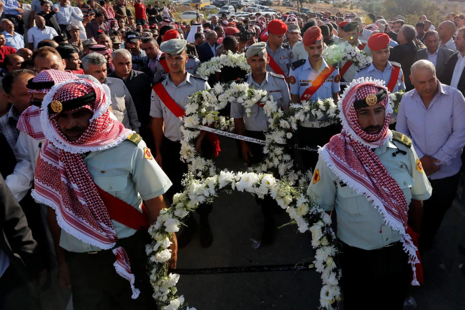 Guard of honor and relatives of Sergeant Hisham Aqarbeh, of the anti-terrorist unit, who was killed during an attack, attend his funeral in Birayn in the city of Zarqa, Jordan, August 12, 2018.REUTERS/Muhammad Hamed
