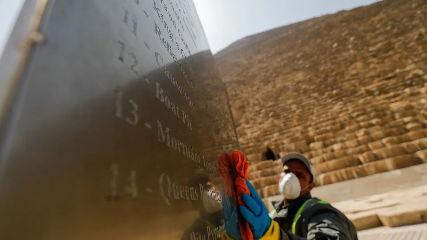 A member of the medical team sprays disinfectant amid concerns over the coronavirus at the Great Pyramids, Giza, on the outskirts of Cairo, Egypt, March 25, 2020.  (Reuters)