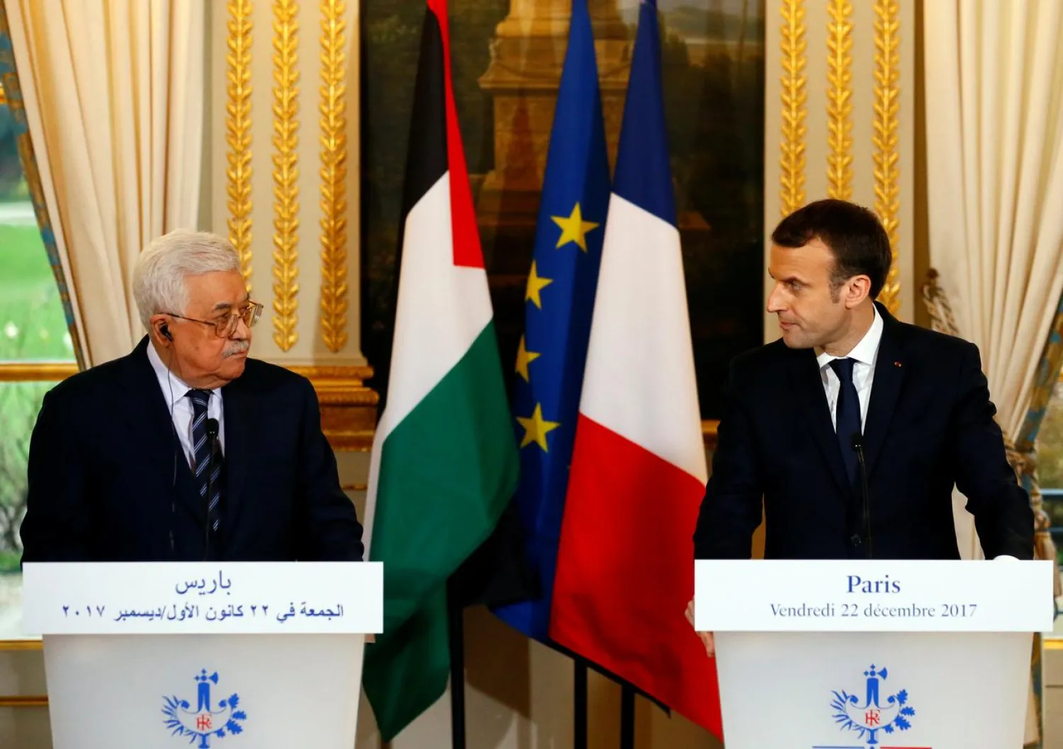 French President Emmanuel Macron (R) and Palestinian President Mahmoud Abbas deliver a press statement after a meeting at the Elysee Palace in Paris, France, December 22, 2017. (Reuters)