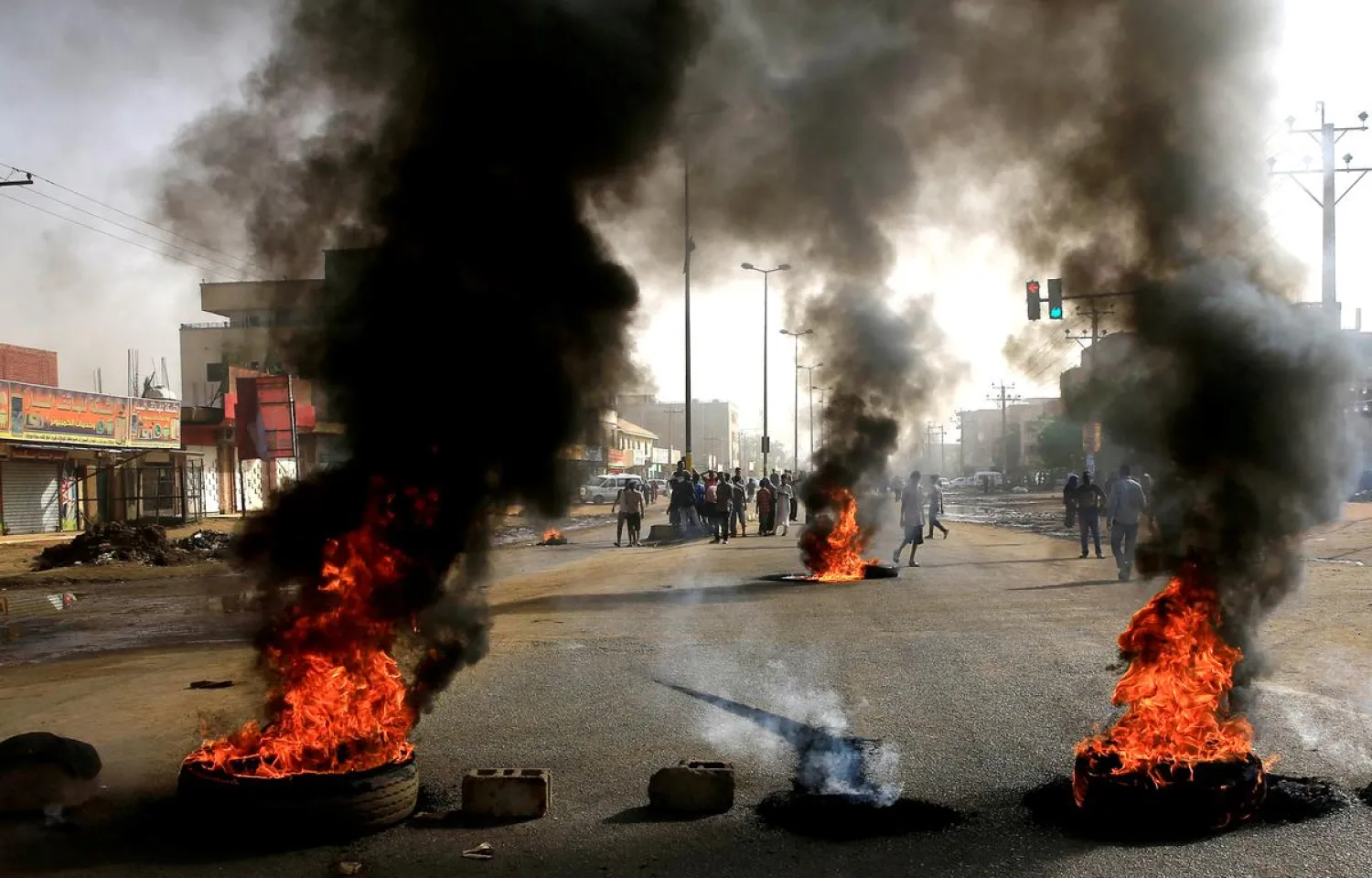 Protesters use burning tires to erect a barricade on a street, demanding that the country's Transitional Military Council hand over power to civilians, in Khartoum, Sudan June 3, 2019. (Reuters)