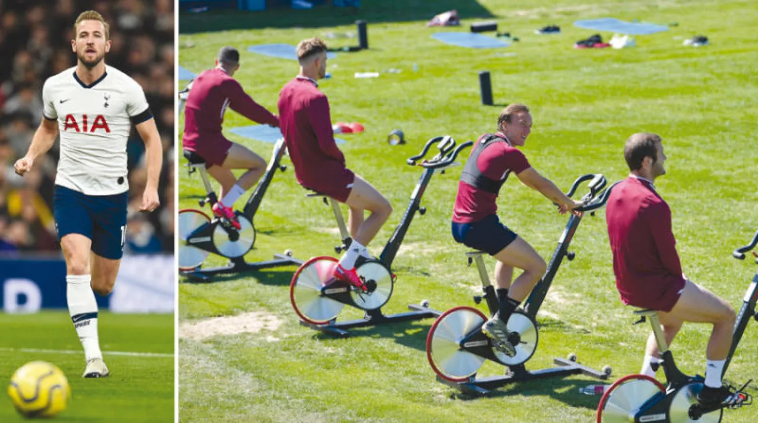 لاعبو وستهام يتبعون القواعد الصحية خلال التدريب قبل استئناف الدوري (غيتي)  -  هاري كين نجم توتنهام استفاد من فترة التوقف للتعافي من الإصابة (أ.ف.ب)