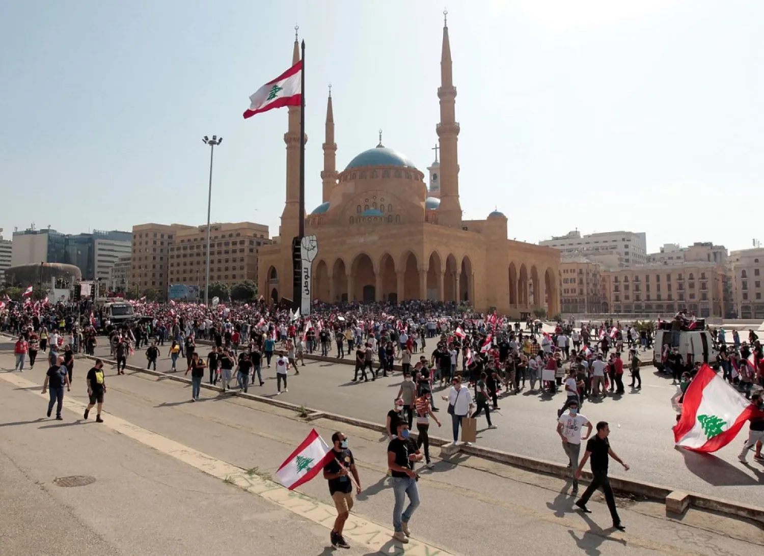 Demonstrators gather as they hold Lebanese flags during a protest against the government performance and worsening economic conditions, in Beirut, Lebanon June 6, 2020. (Reuters)