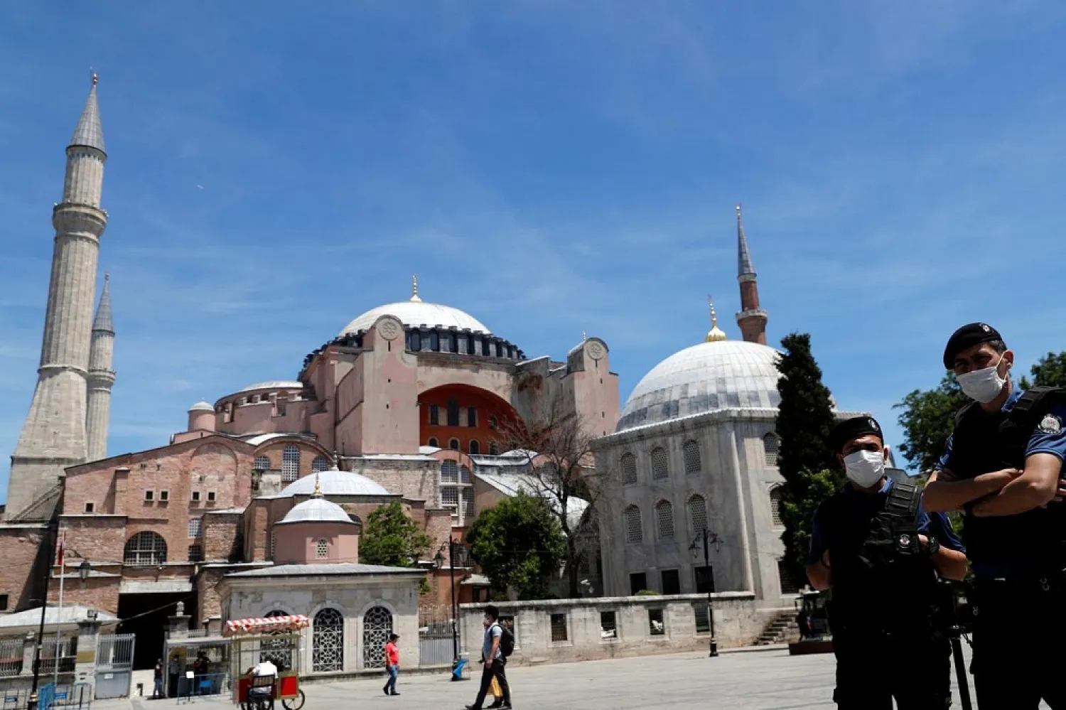 Turkish police officers, with the Byzantine-era monument of Hagia Sophia, now a museum, in the background, patrol at Sultanahmet Square, in Istanbul, Turkey, June 5, 2020. (Reuters)