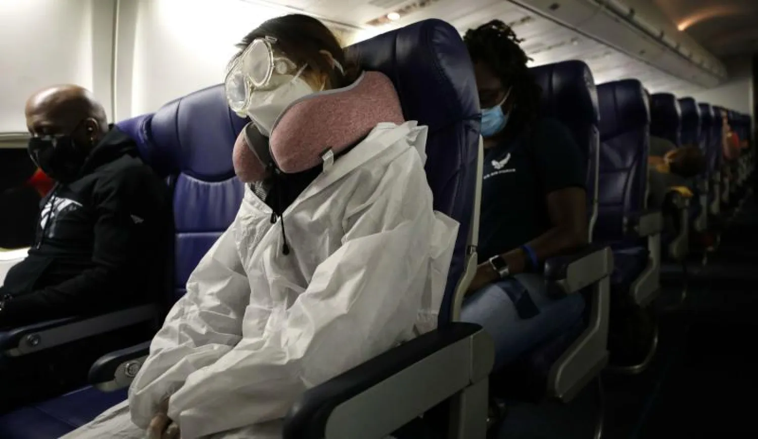 راكب يرتدي بدلة حماية كاملة خلال رحلة طيران لخطوط «ساوث ويست» الجوية من لوس أنجليس إلى هيوستن (أ.ف.ب)