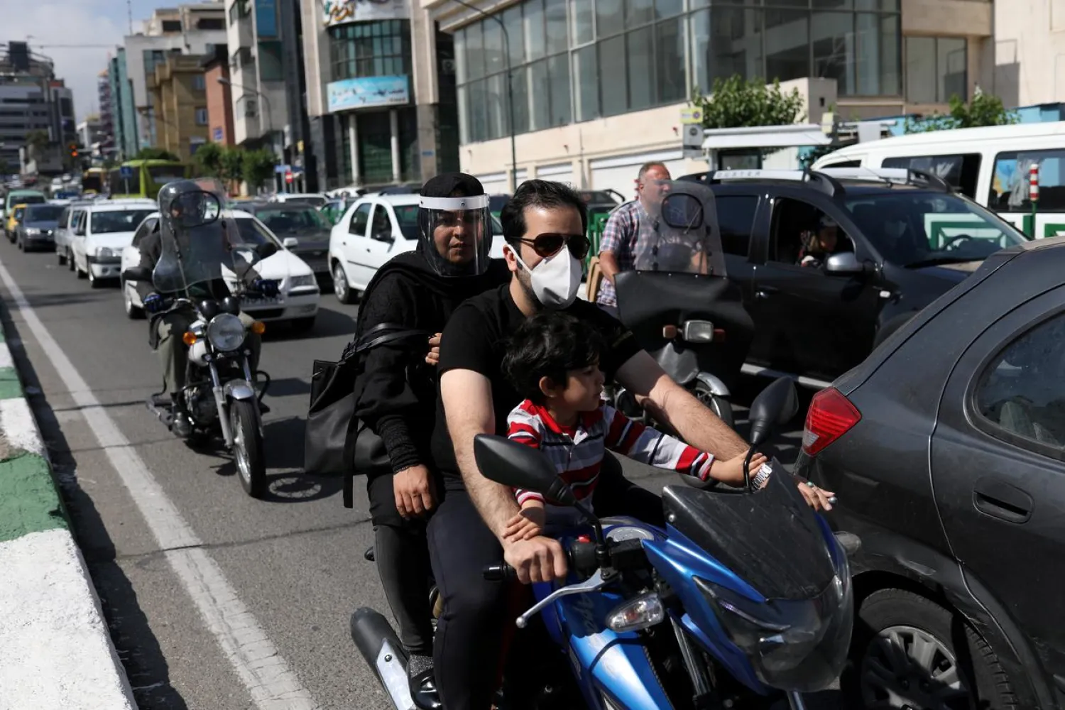 FILE PHOTO: Iranians wear protective masks and face shields against possible coronavirus contagion in Tehran, Iran, May 20, 2020. WANA (West Asia News Agency)/Ali Khara via REUTERS