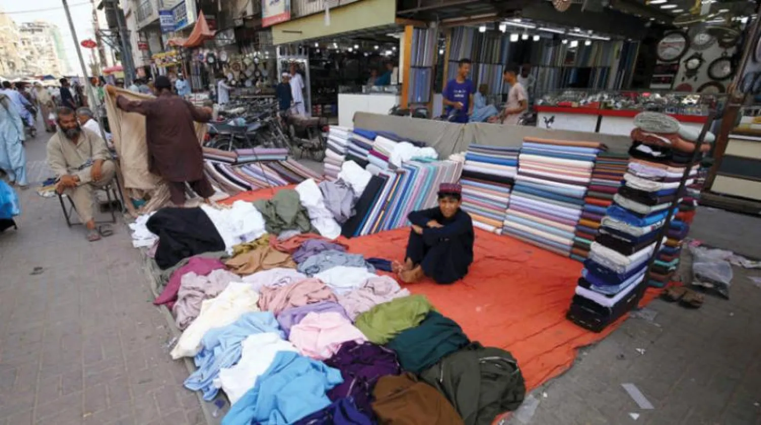 Pakistan’ın Karaçi’de kumaş satan bir çocuk (EPA)