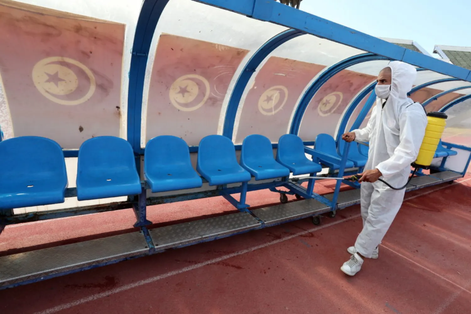 A health worker sprays disinfectant at Tunis’ Olympic El Menzah Stadium amid the COVID-19 outbreak. (EPA)