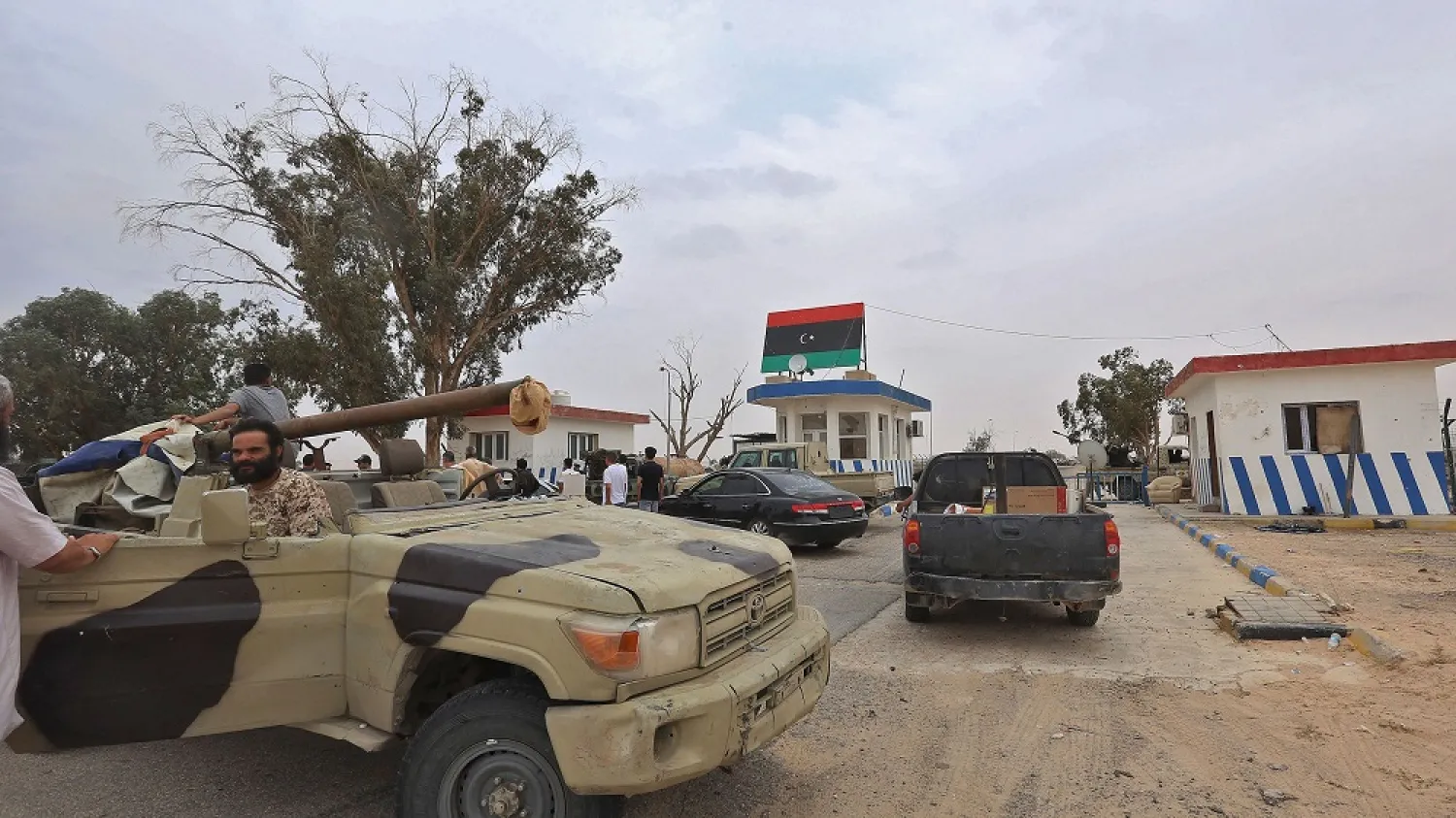 Vehicles of forces loyal to the GNA are seen outside a checkpoint at al-Watiya airbase southwest of the capital, Tripoli, on May 18, 2020. (Getty Images)
