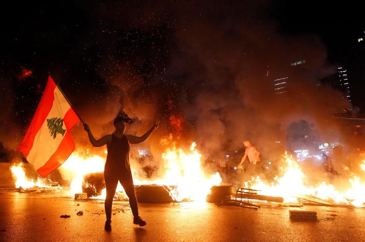 A protester waves the Lebanese on the highway in Jal al-Dib area north of the Lebanese capital. (EPA)
