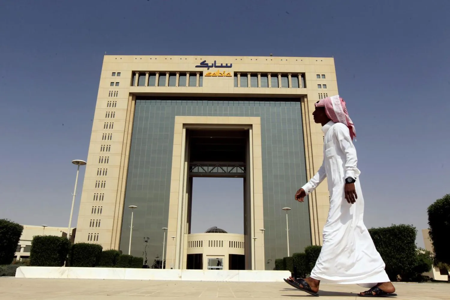 A man walks past the headquarters of Saudi Basic Industries Corp (SABIC) in Riyadh, Saudi Arabia October 27, 2013. REUTERS/Faisal Al Nasser/File Phot