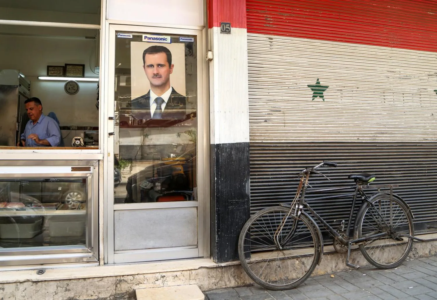 A picture of Syrian president Bashar Assad is seen on a door of a butcher shop in Damascus, Syria. (Reuters)