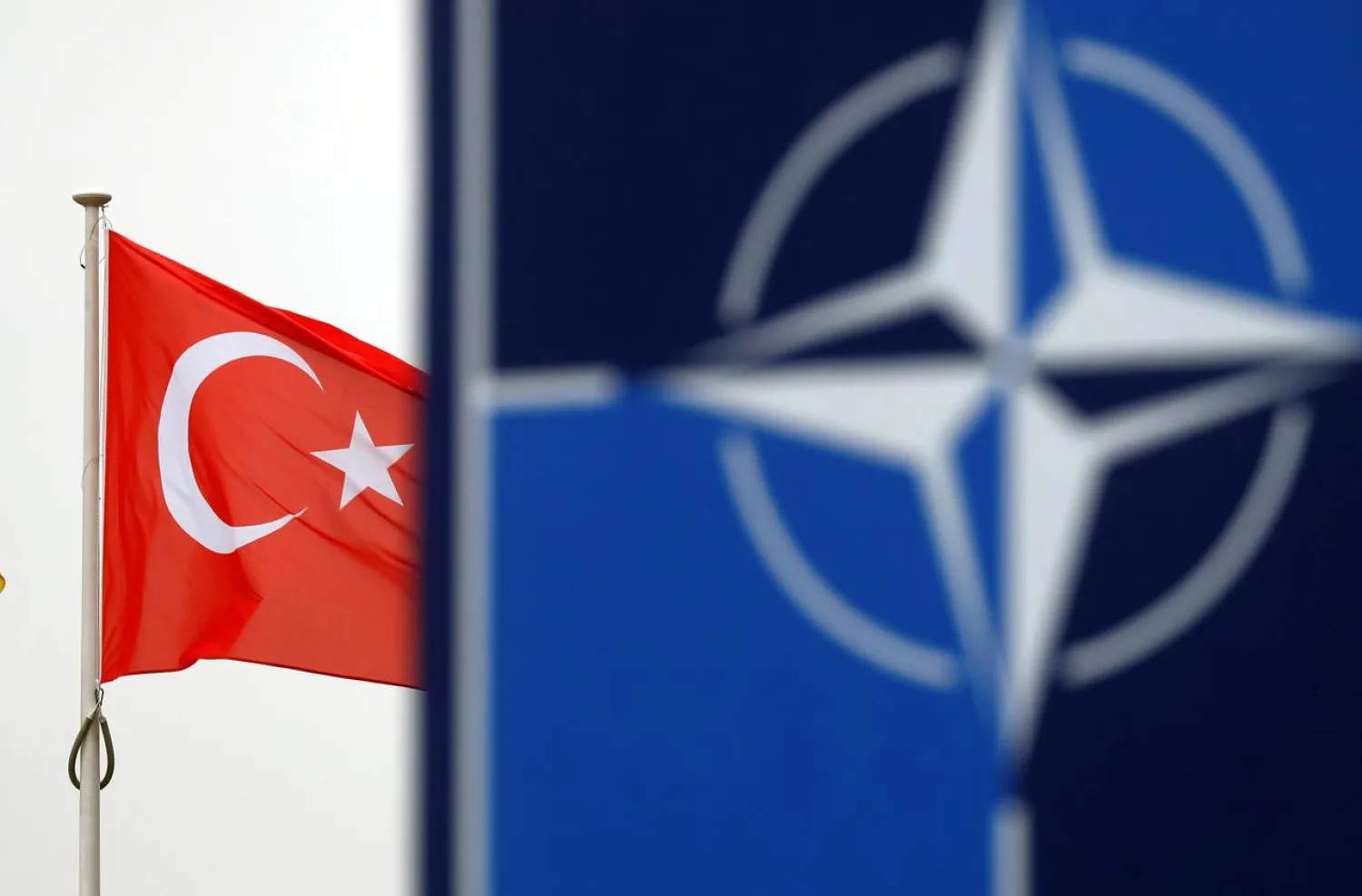 A Turkish flag flies next to NATO logo at the Alliance headquarters in Brussels, Belgium, November 26, 2019. (Reuters)