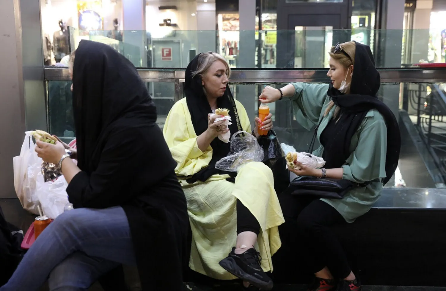 In this Wednesday, June 10, 2020, photo, people have their lunch in a shopping center at the Tehran's Grand Bazaar in Iran. (AP)