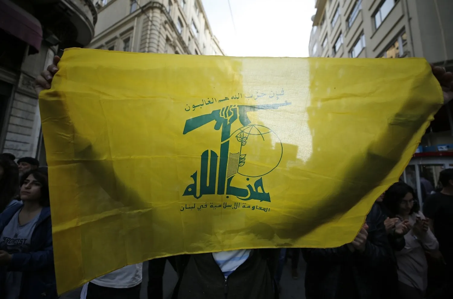 A protester holding a flag of Lebanon's Hezbollah party marches during a demonstration in Istanbul, Tuesday, May 15, 2018. (AP)