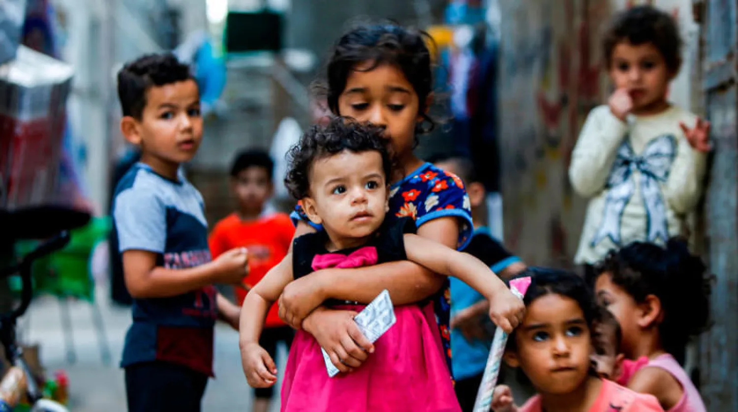 مخيم الشاطئ بغزة في يوم اللاجئين العالمي أمس (أ.ف.ب)