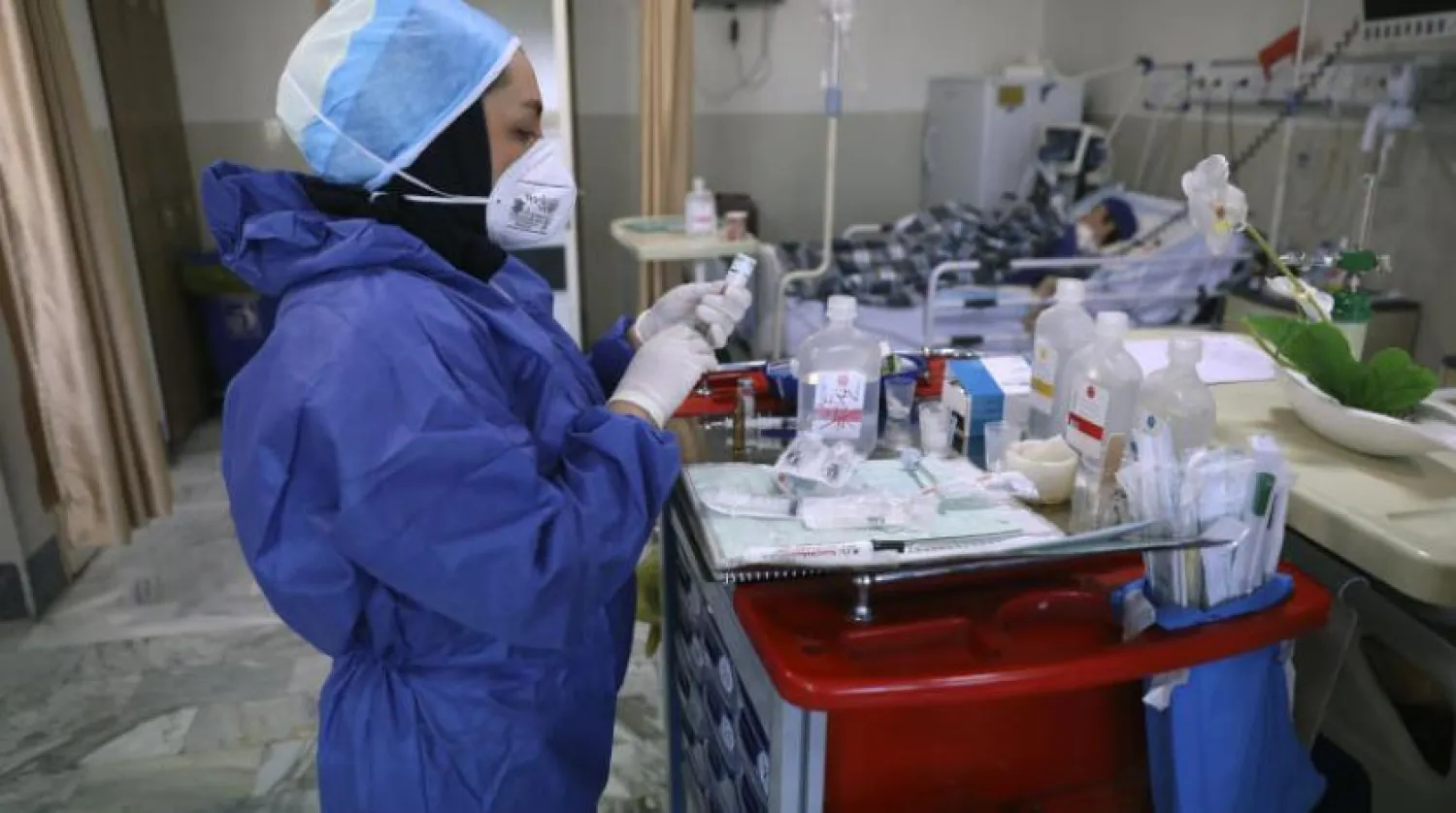 In this Tuesday, June 16, 2020, photo, a nurse prepares medicines for COVID-19 patients at the Shohadaye Tajrish Hospital in Tehran, Iran. (AP Photo/Vahid Salemi)