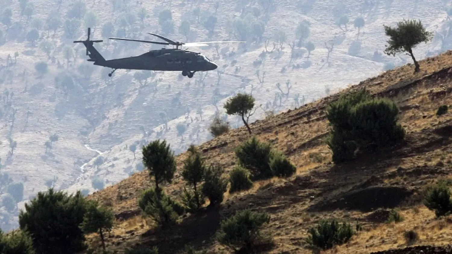 In this file photo, a Turkish army helicopter flies over mountains in the province of Sirnak, near the Turkish-Iraqi border (AFP)