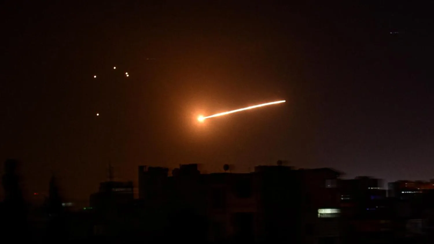 An air strike is seen in the sky is seen in Damascus, Syria, in this handout released by SANA on February 24, 2020. (SANA via Reuters)